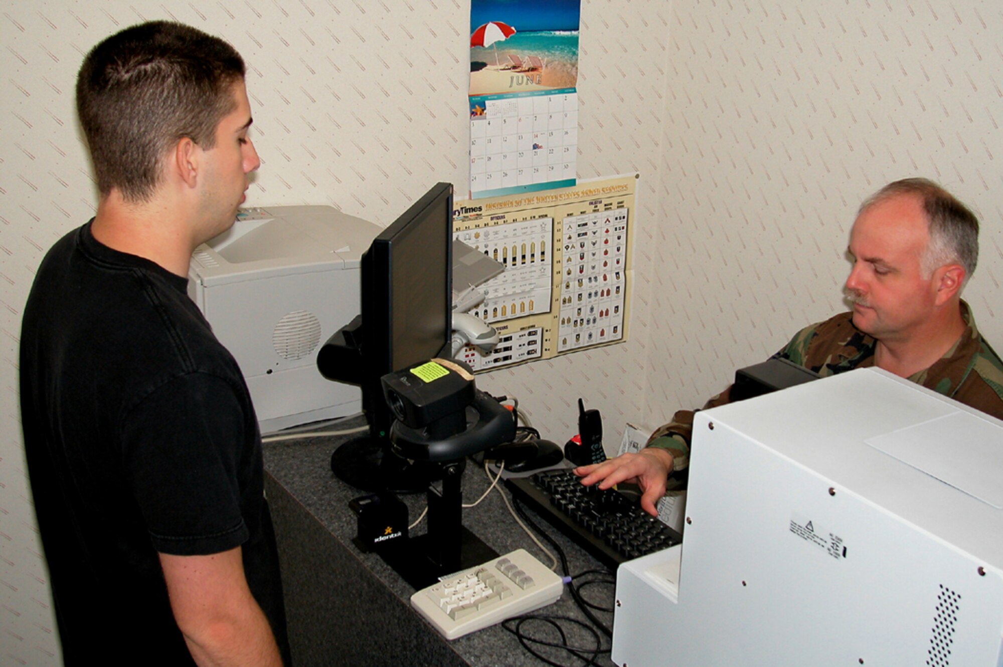 GRISSOM AIR RESERVE BASE, Ind., -- Master Sgt. Ron Wright, 434th Air Refueling Wing customer service chief, creates a new common access card for Airman 1st Class Christopher Stahl of the 434th Security Forces Squadron.  Sergeant Wright warns that new CACs have a thinner profile that may cause connection problems with current CAC readers. (U.S. Air Force photo/Senior Airman Chris Bolen)
