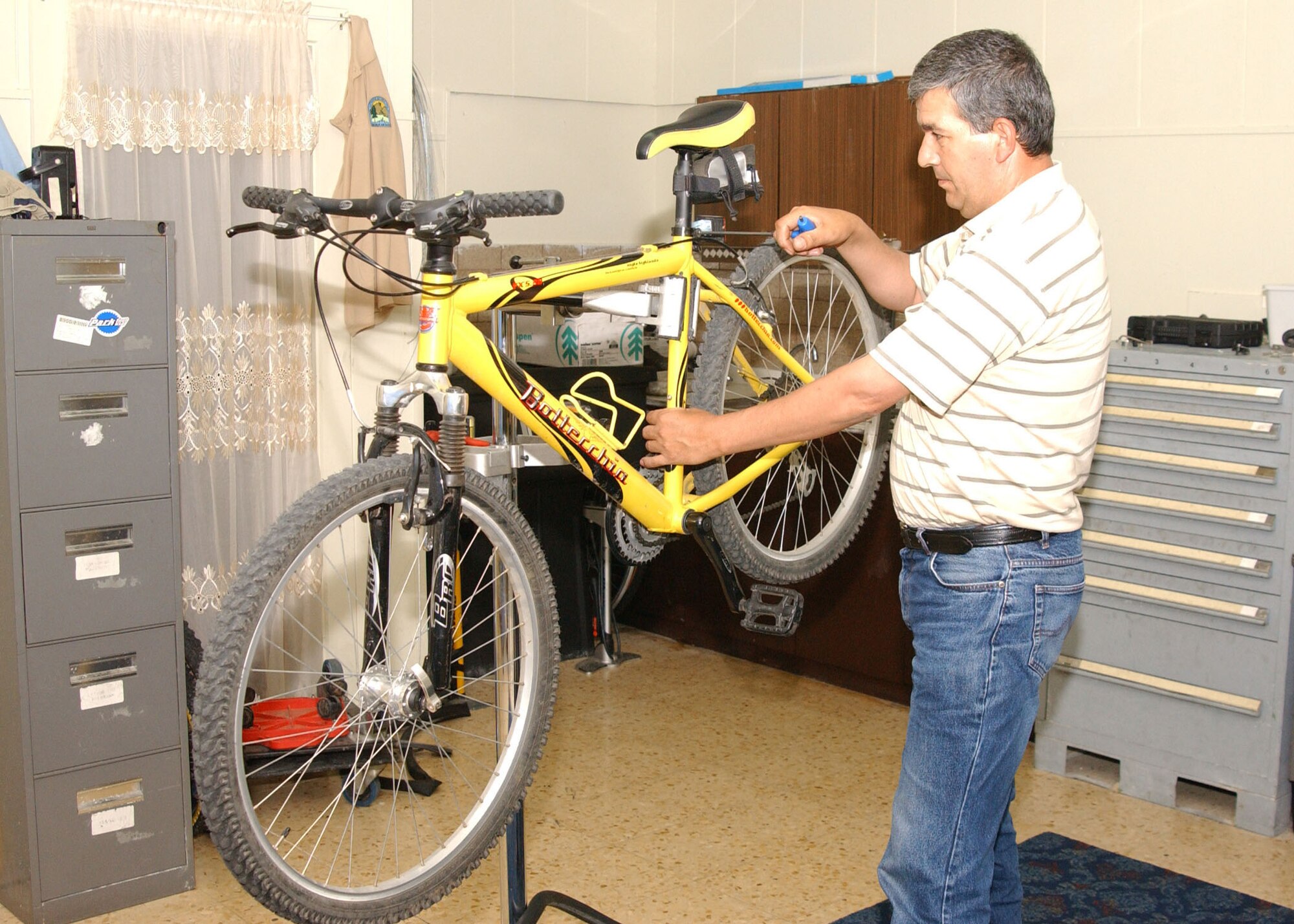 Sabahattin Daglioglu, Outdoor Recreation bike repairman, fixes a bike at the ODR.  He does everything from flat tires to bike reconstruction and tune-ups. (U.S. Air Force photo by Tech. Sgt. Patrick Hyde)
