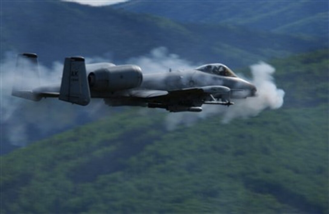 A U.S. Air Force A/OA-10 Thunderbolt II from the 355th Fighter Squadron is surrounded by a cloud of gun smoke as it fires a 30mm GAU-8 Avenger Gatling gun over the Pacific Alaska Range Complex in Alaska on May 29, 2007.  The seven-barrel Gatling gun can be fired at a rate of 3,900 rounds per minute.  