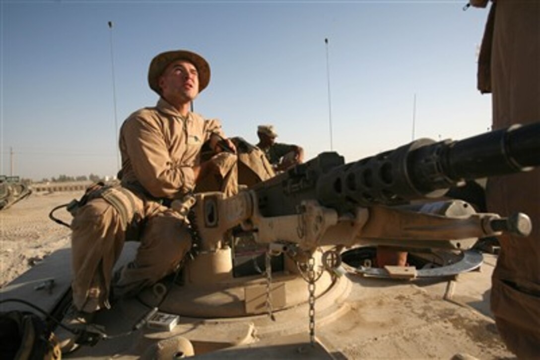 U.S. Marine Corps Staff Sgt. Jonathan L. Rodriguez performs a final inspection on his M1A1 Abrams tank before heading out to patrol the main supply routes surrounding Al Fallujah, Iraq, on June 6th, 2007.  Rodriguez and his fellow Marines from the 2nd Tank Battalion, Regimental Combat Team 6 are patrolling the main supply routes to keep them clear of anti-Coalition force activity.  