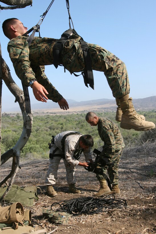 FIRE BASE GLORIA, MARINE CORPS BASE CAMP PENDLETON, Calif. ?Marines with Weapons Company, Battalion Landing Team 1st Battalion, 5th Marine Regiment, 11th Marine Expeditionary Unit learn combat climbing techniques prior to  moving out on an exercise during a tactical recovery of aircraft and personnel (TRAP) training exercise June 12, here. Marines with the BLT conducted four separate missions involving different scenarios and in both day and night time conditions. The training was instructed and carried out by Special Operations Training Group, I Marine Expeditionary Force from here.