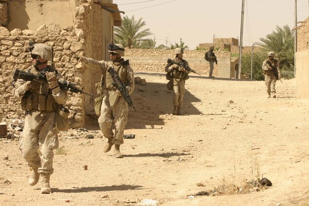 14 June 2007, Marines of 2nd Squad, 3rd Platoon, Charlie Company, 1st Battalion, 3d Marine Regiment (1/3), enter the perimeter of the forward operating base of Haqlaniyah, Iraq.  The Marines are returning from a census patrol, in which they gathered information and population counts.::n::1/3 is deployed with Multi National Forces-West in support of Operation Iraqi Freedom in the Al Anbar province of Iraq to develop Iraqi Security Forces, facilitate the development of official rule of law through democratic reforms, and continue the development of a market based economy centered on Iraqi reconstruction. (Official USMC photograph by Cpl. Stephen M. Kwietniak)::n::