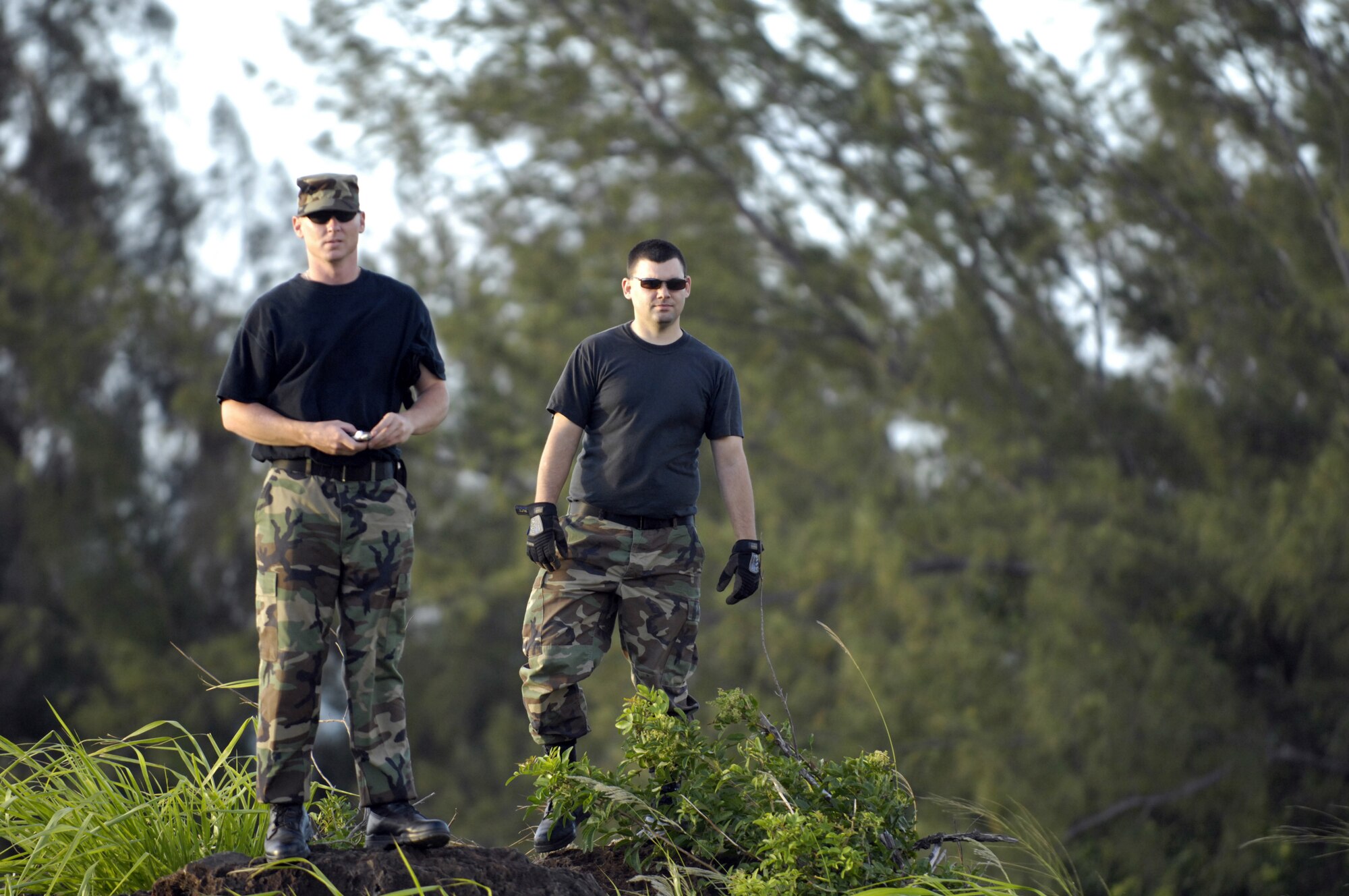 Staff Sgt. Robert Ward and Airman 1st Class Justin Stevens watch as C-17 Globemaster III’s practice their quarterly airdrop qualifications at the Kahuku Training Range in Hawaii Monday. The Airmen are from the 15th Logistics Readiness Squadron Combat Mobility Element. The C-17’s are from the 535th Airlift Squadron, Hickam Air Force Base, Hawaii.  (U.S. Air Force photo/ Tech. Sgt. Shane A. Cuomo)