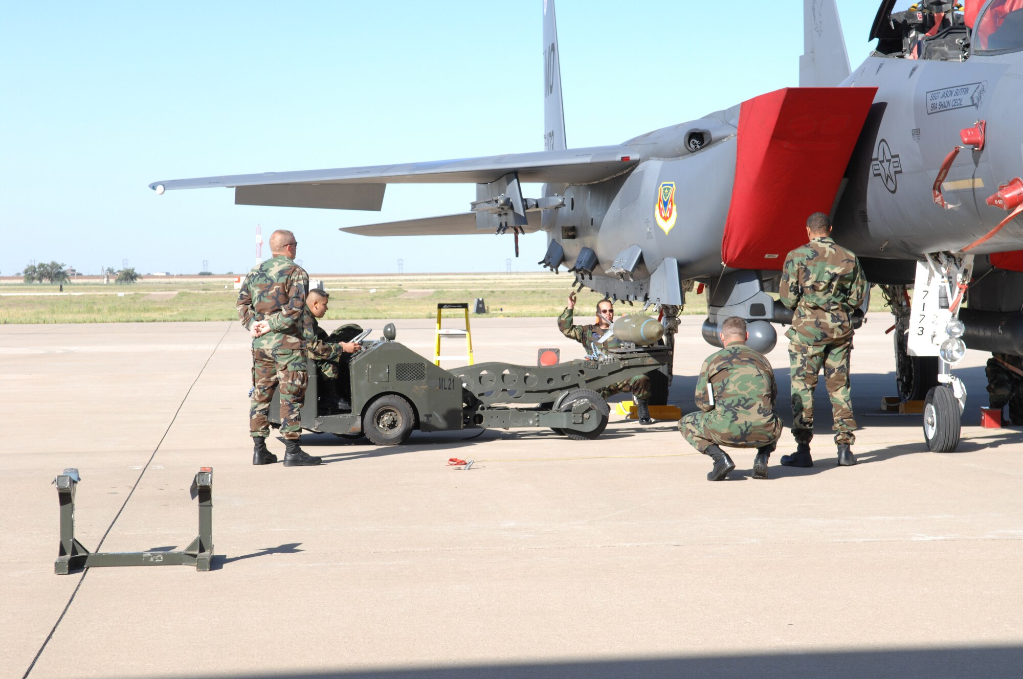 Maintenance crews from the 366th Fighter Wing of Mountain Home Air Force Base, Idaho, load a F-15 during the weapons load portion of the Pioneer Airfest. The Pioneer Airfest was held at Cannon AFB June 8 and consisted of a weapons-loading competition and a bomb-dropping competition. (U.S. Air Force photo by Staff Sgt. April Wickes)
