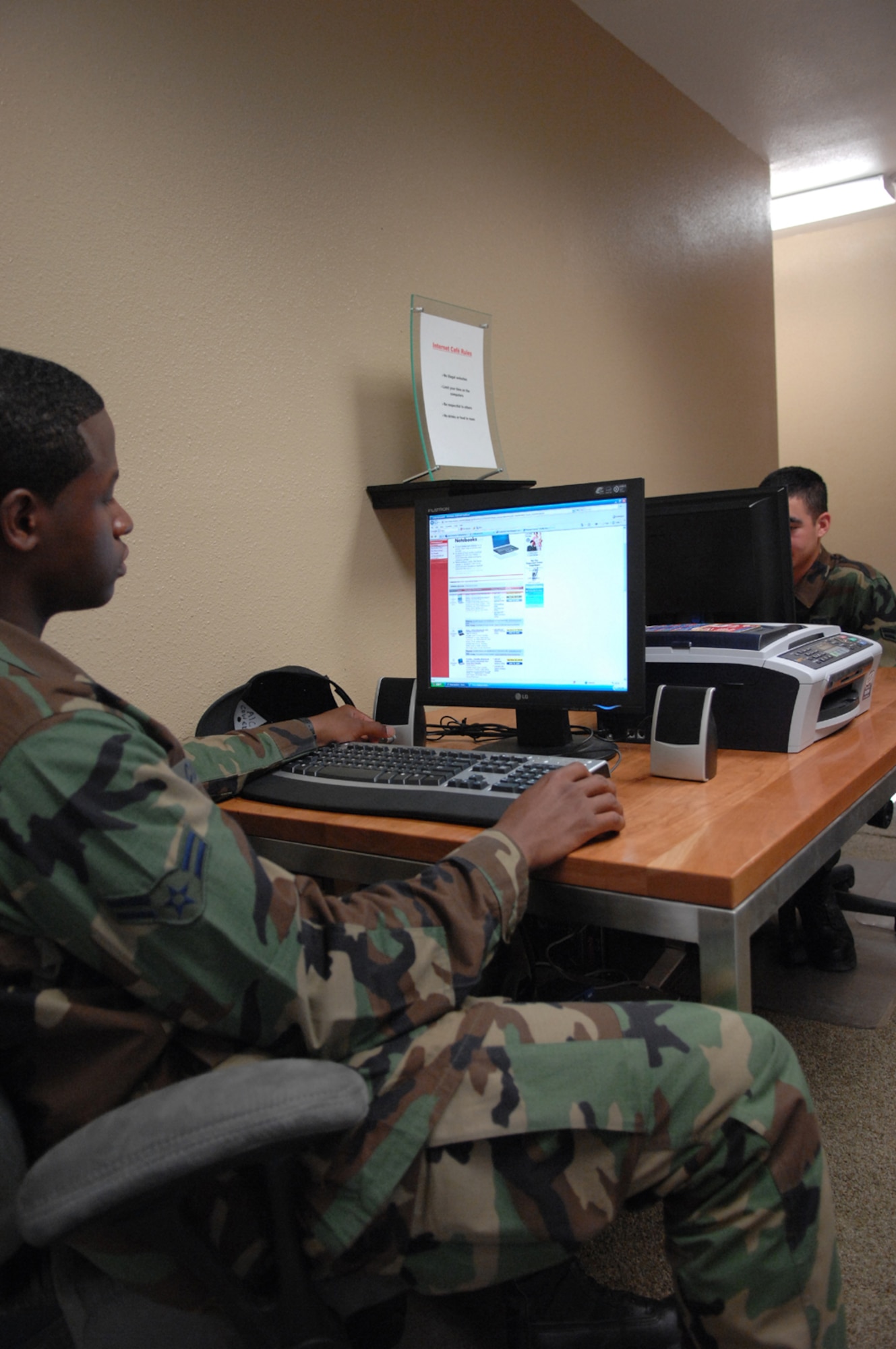 Airman First Class Andrew Cowell, 99th Civil Engineer Squadron, surfs the internet at the internet cafe inside the new Nellis Airmen's Center June 12.
(U.S Air Force Photo/Senior Airman Larry E. Reid Jr.)