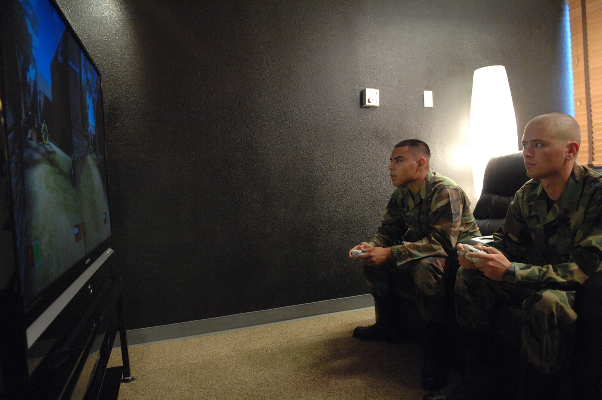 Airman First Class Nori Flores (left), 57th Aircraft Maintenance Squadron F-16 Avionics Apprentice and Brandon Bell, 57th Equipment Maintenance Squadron Ammo Technician, plays a game of Tom Clancy's Ghost Recon on the new Microsoft X-Box 360 in one of the two video gaming rooms inside the new Nellis Airmen's Center June 12.
(U.S Air Force Photo/Senior Airman Larry E. Reid Jr.)