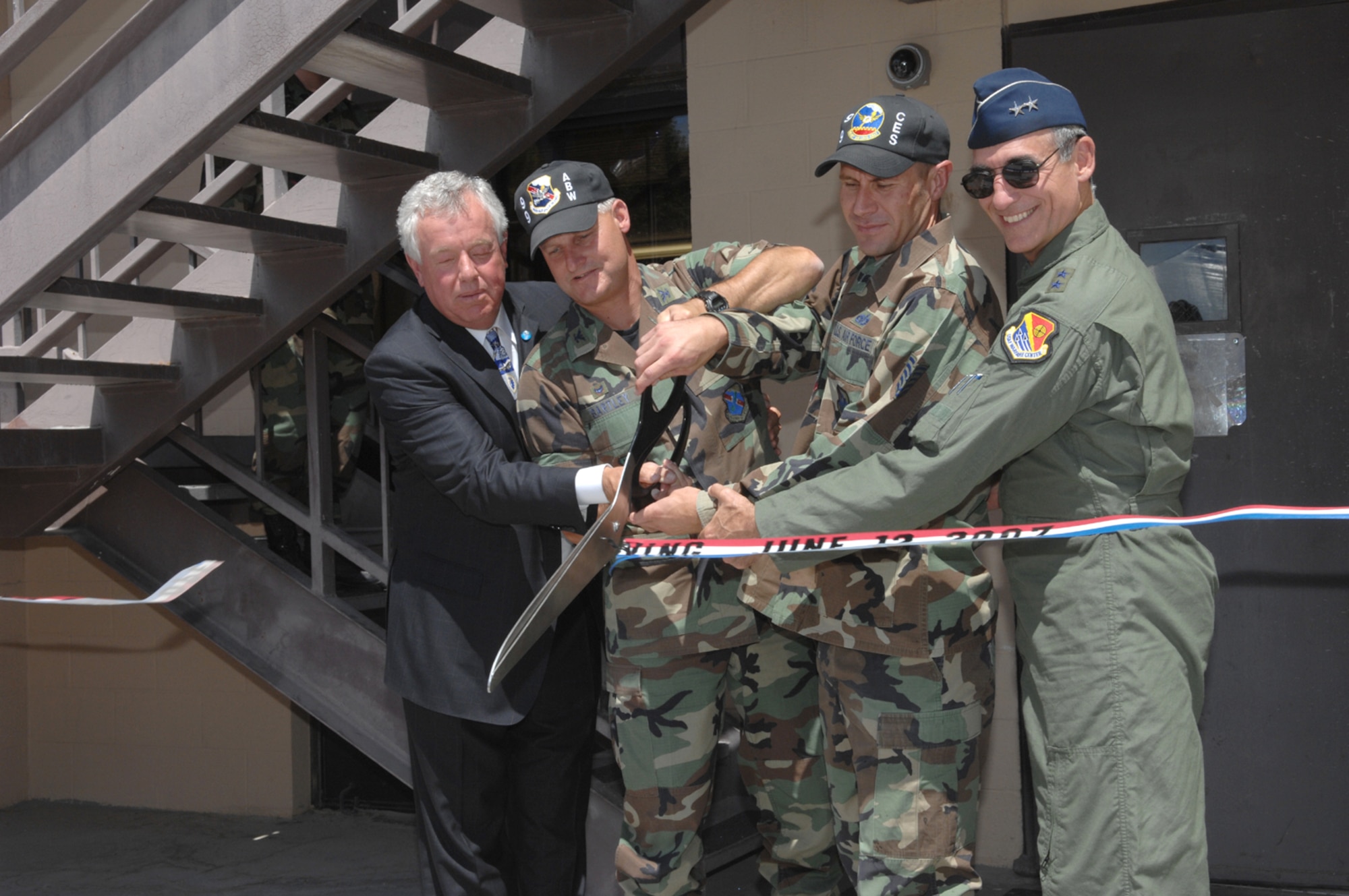 (from left to right) Mr. Randy Black, Colonel Michael Bartley, 99th Air Base Wing Commander, Technical Sergeant Mark Kerr, project manager, and Major General R. Michael Worden, United States Air Force War Fare Center Commander, officially opens up the newly built Nellis Airmen's Center during a ribbon cutting ceremony  June 12.
(U.S Air Force Photo/Senior Airman Larry E. Reid Jr.)