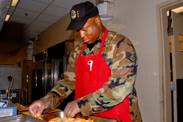 Staff Sgt. Eugene Martin, 437th Services Squadron services craftsman, prepares the evening meal at Charleston AFB's Gaylor Dining Facility June 13.(U.S. Air Force photo/ Capt. Amy Hutchisson) 
