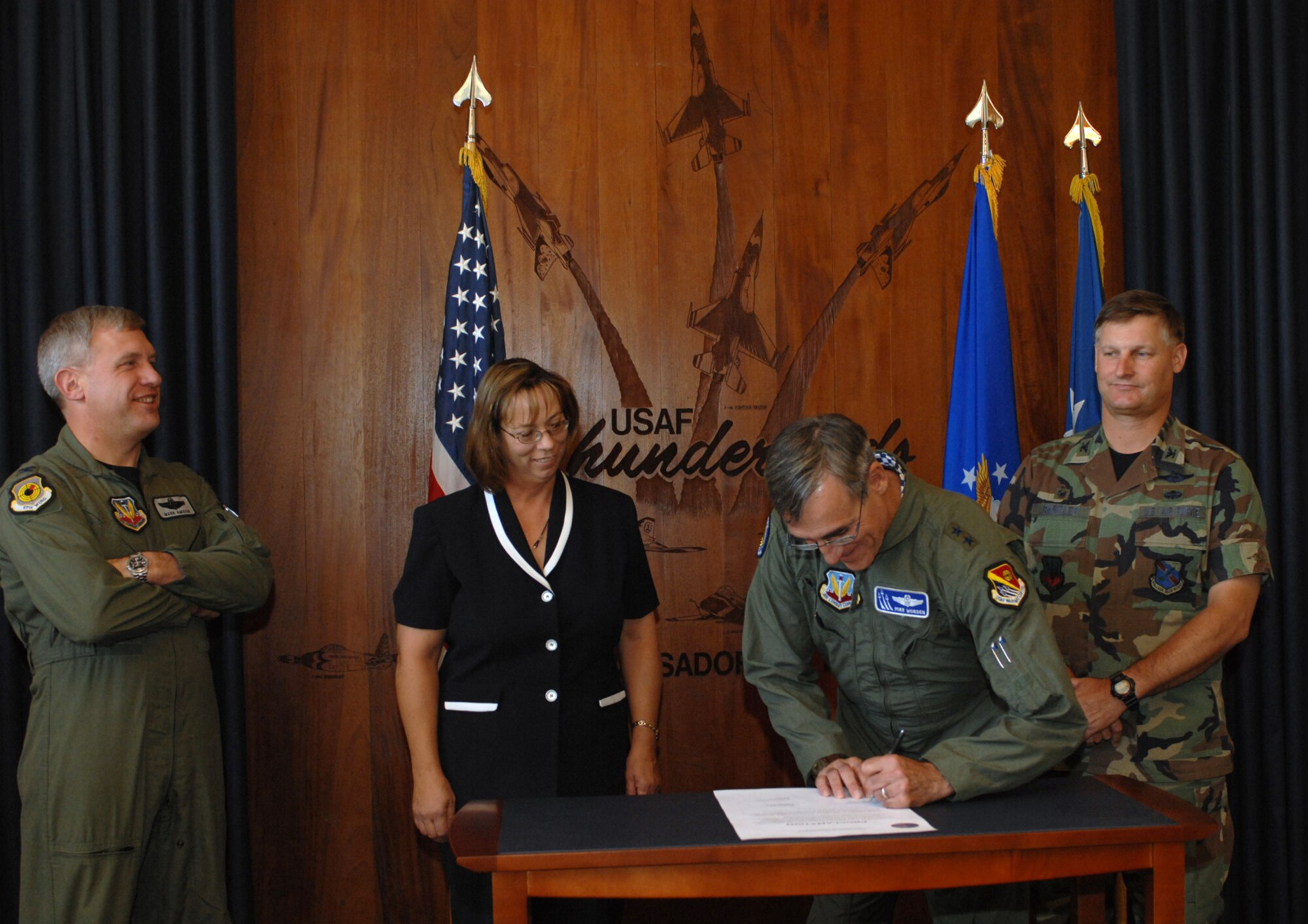 Showing their support of the recently approved 99th Air Base Wing energy policy, (left to right) Col. Mark Amidon, 57th Wing vice commander, Yvonne Gresnick, 98th Range Wing deputy director, Maj. Gen. Mike Worden, U. S. Air Force Warfare Center commander, and Col. Michael Bartley, 99th ABW commander, signed a proclamation affirming their commitment to energy conservation at Nellis and Creech Air Force Bases, as well as the Nevada Test and Training Range, June 12. The energy policy letter and proclamation, along with infrastructure projects and promotion of individual responsibility, make up the three-pronged strategy aimed at reducing energy consumption.
