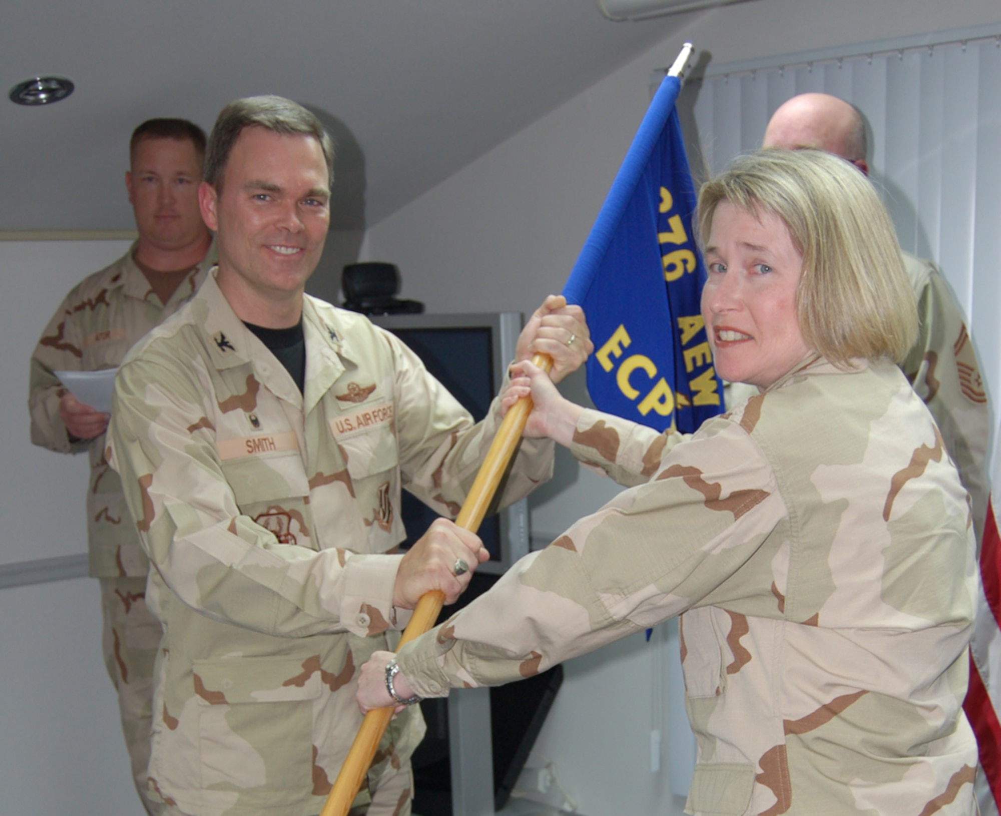 Maj. Gena Stuchbery, 14th Comptroller Squadron, takes the guideon as squadron commander while deployed to the 376th Air Expeditionary Wing. (U.S. Air Force Photo)