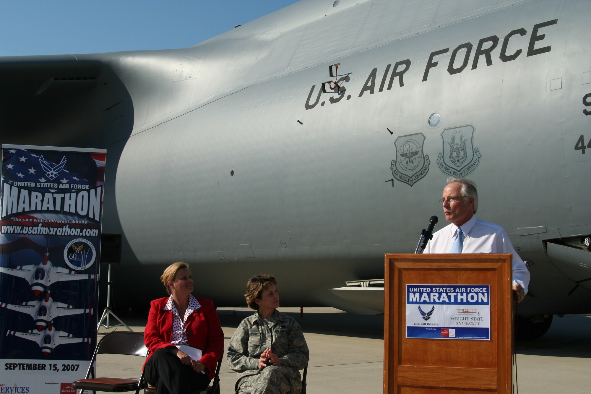 Leadership from both the Air Force and Wright State University gather at a press conference June 13 to discuss their new USAF Marathon partnership, and other details of the September race. On the flightline of the 445th Airlift Wing in front of a massive C-5 Galaxy -- the featured aircraft of the 11th annual race --  are Lt. Gen. Terry Gabreski, vice commander of Air Force Materiel Command, Molly Louden, director of the USAF Marathon, and David R. Hopkins, president of Wright State University, who all took turns speaking to nearly two dozen media members. (Air Force photo by Kathleen A.K. Lopez)
