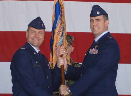Lt. Colonel Charles Hamilton assumes command of the 41st Flying Training Squadron Tuesday during a ceremony in Hangar 4. He is pictured here receiving the unit guideon from Colonel Eric Theisen, 14th Operations Group Commander. (U.S. Air Force Photo by Airman 1st Class Danielle Powell)