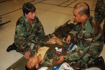 MINOT AIR FORCE BASE, N.D. – Col. June Carraher, 5th Medical Group chief of medical staff, and Staff Sgt. Antonio Managad, 5th Medical Operations Squadron, treat a “tornado victim” during an exercise at Memorial Middle School June 12. The exercise tested the 5th MDG’s ability to perform medical treatment at an alternate location if the 5th MDG facility were to become inoperable during a natural disaster. (U.S. Air Force photo by Airman Sharida Bishop) 