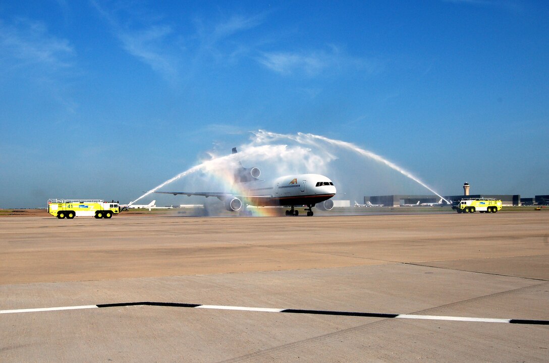 An L-1011 passenger jet carrying U.S. servicemembers and Department of Defense civilians home from Southwest Asia receives a "Shower of Affection" June 12 from the Dallas-Fort Worth International Airport Fire Department as a special welcome home. (U.S. Air Force photo/Tech. Sgt. John Jung)
