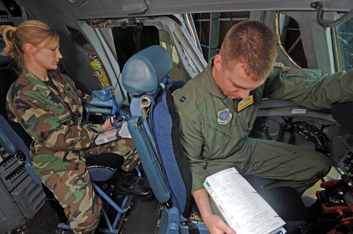 Capt. Scot Frechette, 16th Airlift Squadron pilot, does a saftey check while Staff Sgt. Sarah Hall, 437th Maintenance Squadron crew chief, checks the pilot's mask for defects during a preflight inspection.  (U.S. Air Force photo/Staff Sgt. April Quintanilla)