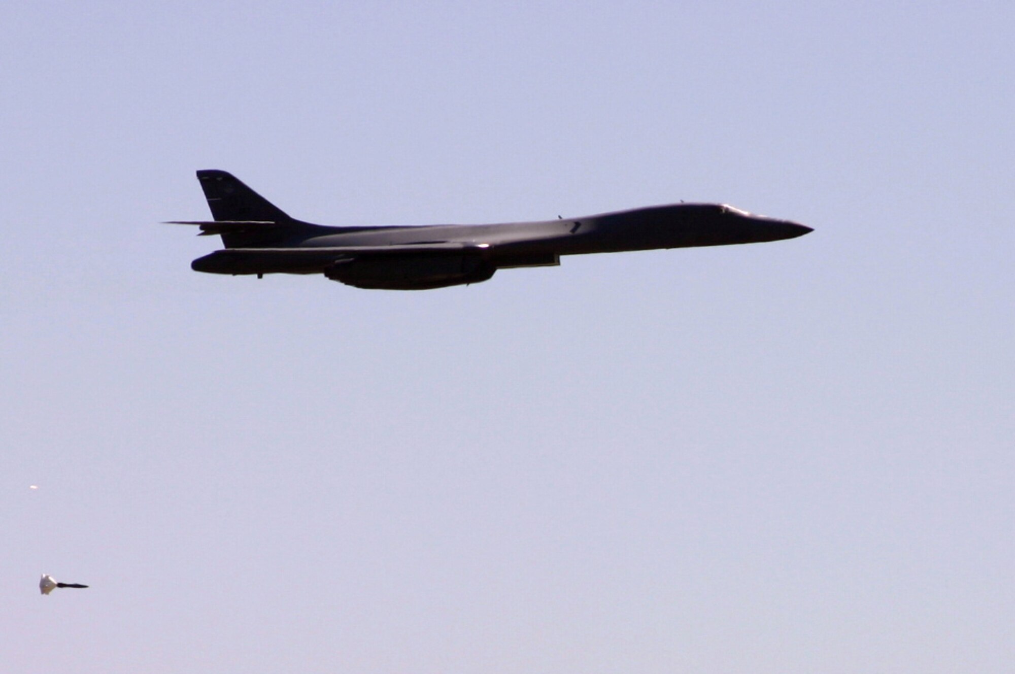 A B-1 bomber drops a bomb during the bomb-dropping competition at the Pioneer Airfest. The 7th Bomber Wing at Dyess Air Force Base, Texas won the bomb-dropping competition. The Pioneer Airfest was held at Cannon AFB June 8 and consisted of a weapons-loading competition and a bomb-dropping competition. (U.S. Air Force photo by Airman Elliott Sprehe)
