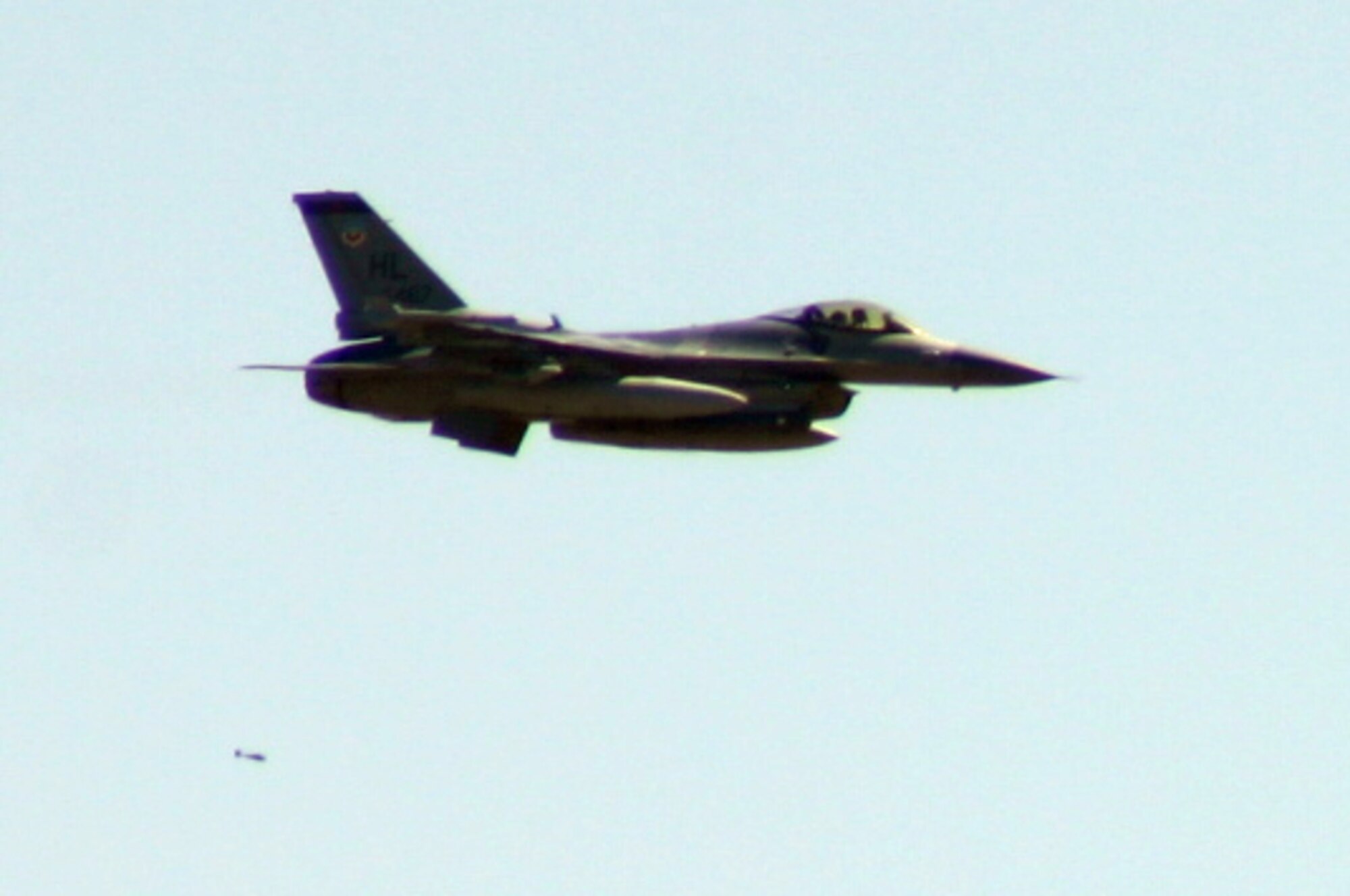 An F-16 from the 388th Fighter Wing at Hill Air Force Base, Utah, drops a bomb during the bomb-dropping portion of the Pioneer Airfest. The Pioneer Airfest was held at Cannon AFB June 8 and consisted of a weapons-loading competition and a bomb-dropping competition. (U.S. Air Force photo by Airman Elliott Sprehe)