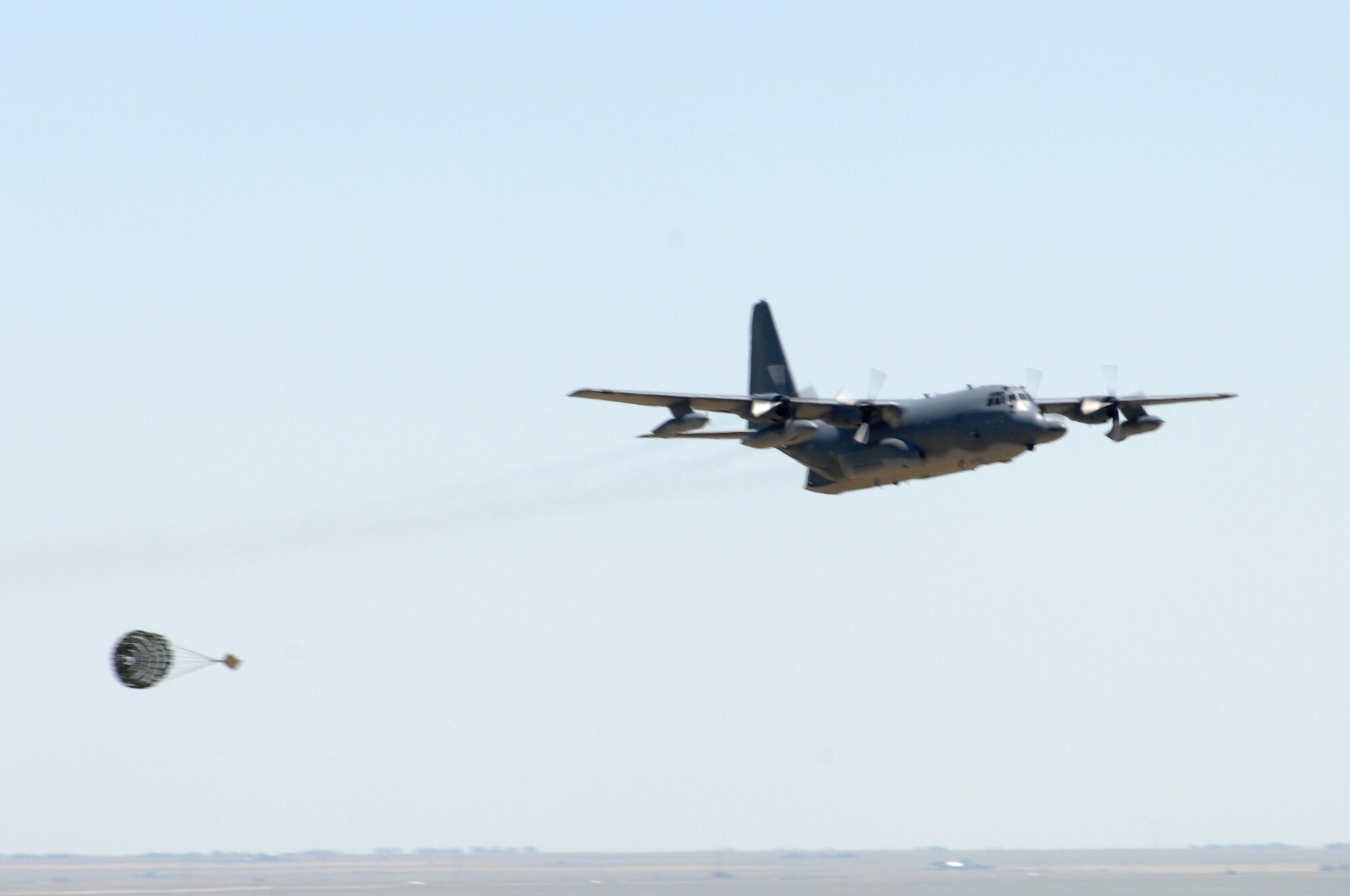 A C-130 from the 1st Special Operations Wing at Hurlburt Field, Fla., does a mock cargo drop as the final event of the Pioneer Airfest. The Pioneer Airfest was held at Cannon Air Force Base June 8 and consisted of a weapons-loading competition and a bomb-dropping competition. (U.S. Air Force photo by Airman 1st Class Randi Flaugh)