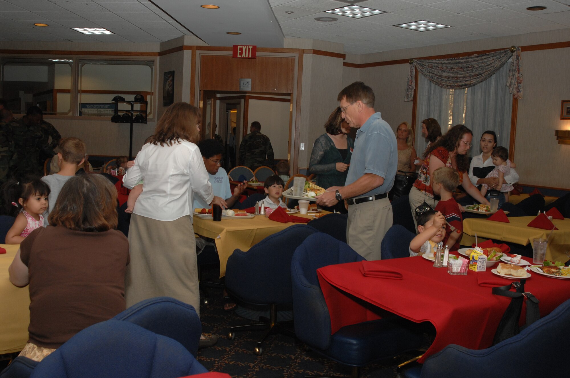 Family members of deployed and remote spouses enjoy a dinner June 12 at the Pecos Trail Dining Facility put on by Hearts Apart. Hearts Apart has monthly events for family members of deployed and remote spouses. Over 150 people attended the dinner. (U.S. Air Force photo by Senior Airman Heather Redman)
