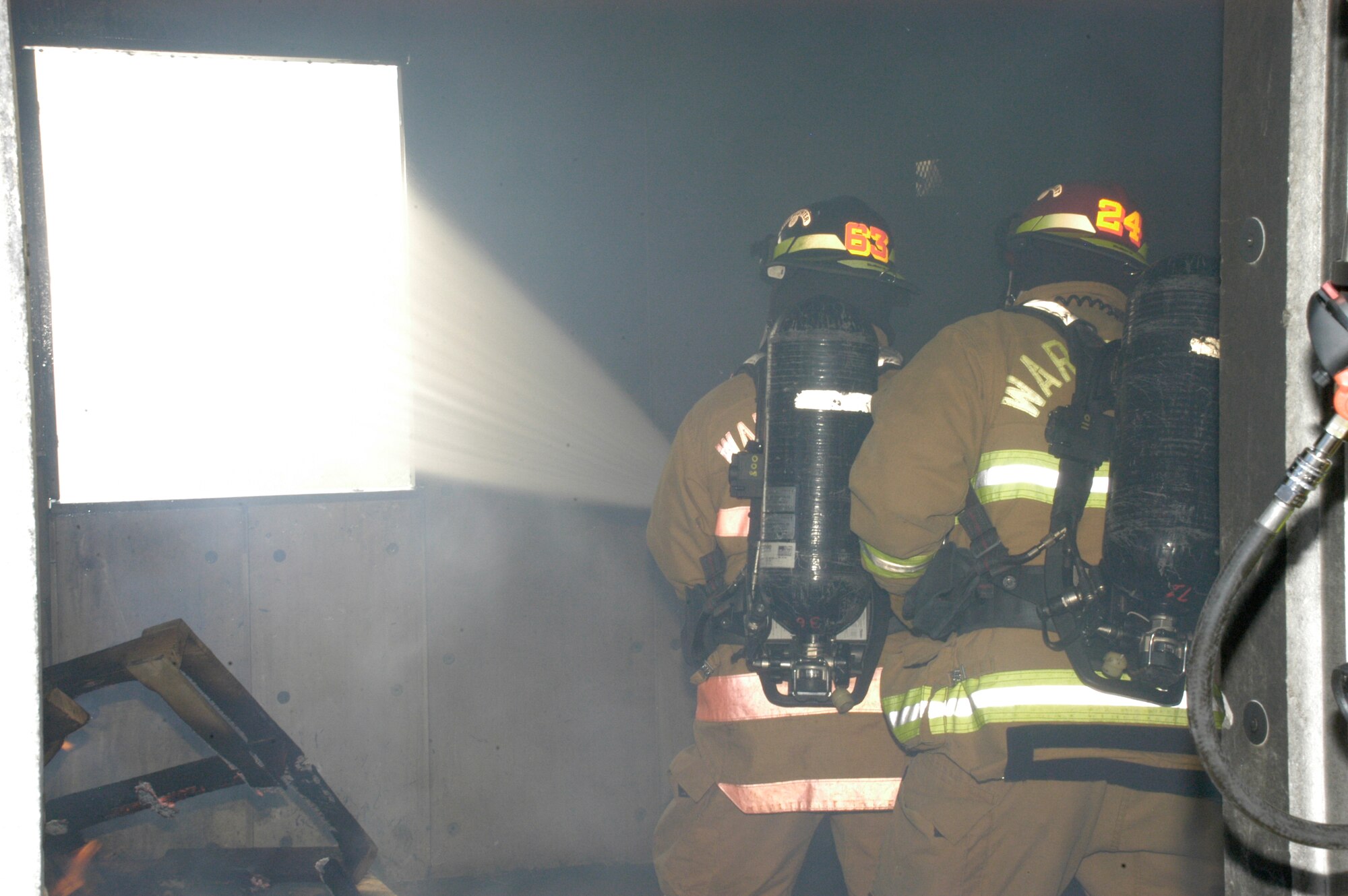 Airman Stephen Colucci extinguishes the fire while Staff Sgt. Nate Pyle observes and critiques the technique. This was Airman Colucci’s first training fire since arriving to Warren.
