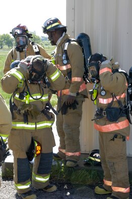 Members of the Warren Fire Department prepare for a live-fire training exercise held here May 31 at the training grounds at Bldg. 1340. The fire department runs four to five of these “control burns” a year for annual training (Photos by Staff Sgt. Chad Thompson).