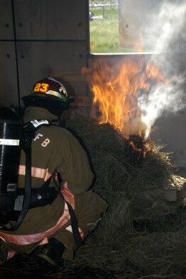 Tech. Sgt. Michael Falzone ignites the fire for the live-fire exercise. Fires in Bldg. 1340 can reach 700 degrees, but it has built-in fans to regulate the temperature for training purposes.