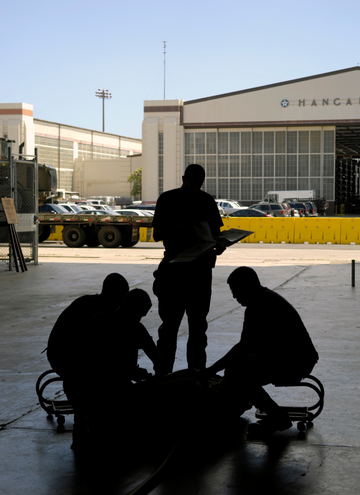 Air transportation specialists pack a parachute in Hanger 7 at Hickam Air Force Base, Hawaii June 11, 2007. The Airmen are from the 15th Logistics Readiness Squadron Combat Mobility Element. They are preparing the parachute to be rigged to a practice airdrop bundle. (U.S. Air Force photo/ Tech. Sgt. Shane A. Cuomo) 