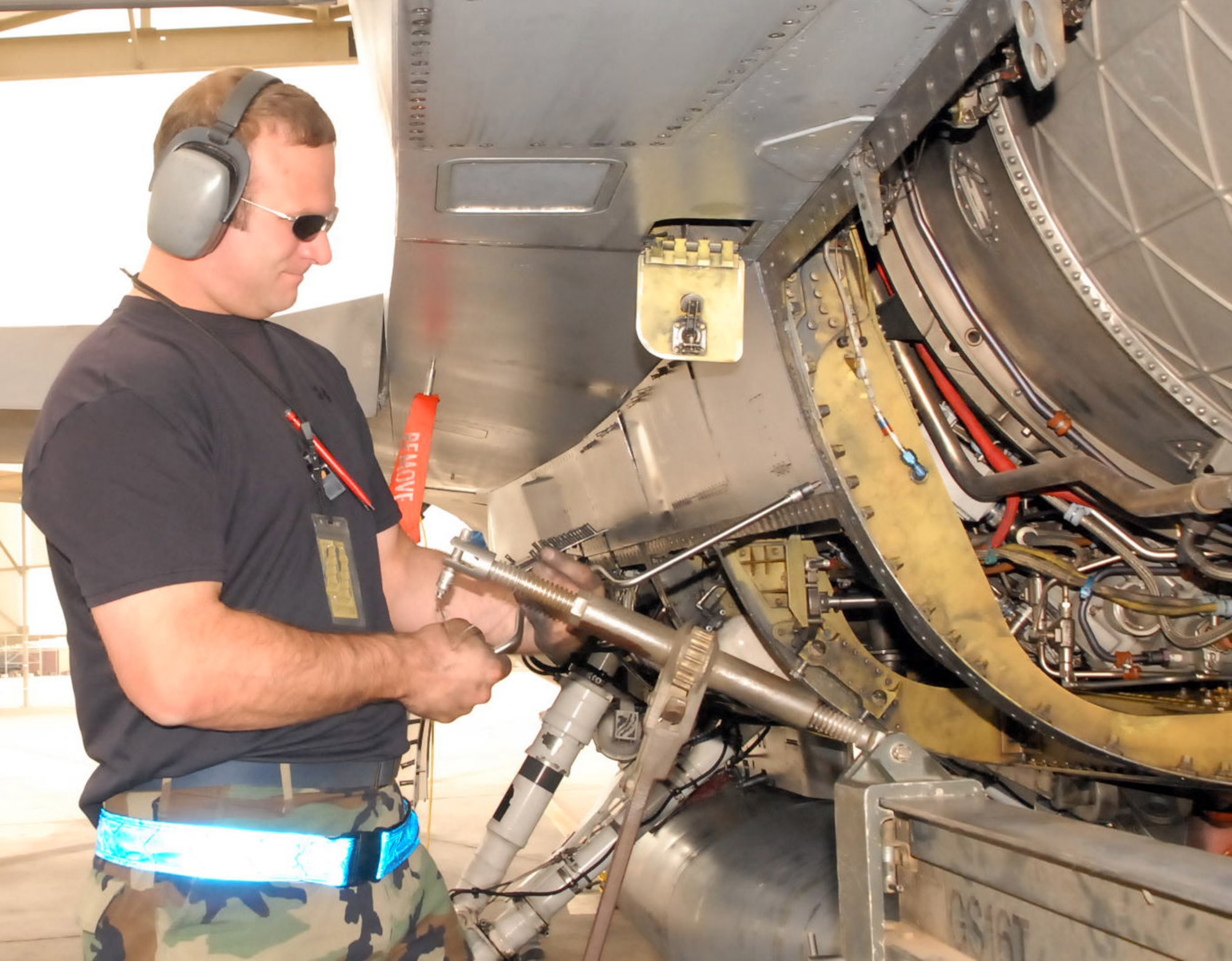 Staff Sgt. Jeff Frezley, 62nd Aircraft Maintenance Unit dedicated crew chief, removes an access panel Monday in order to disconnect pipes and hoses from the engine during an F-16 engine removal. Photo by Phillip Butterfield