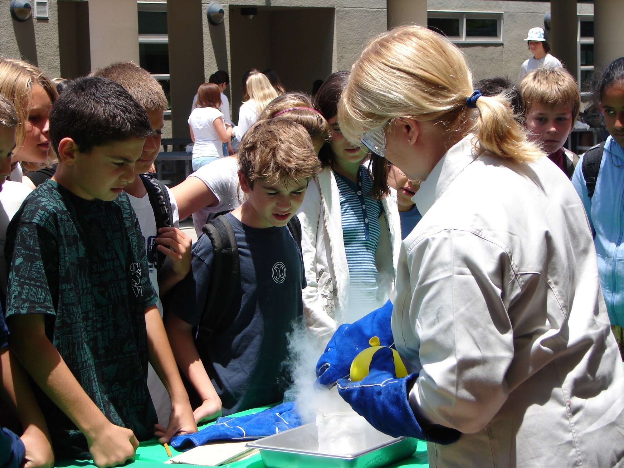 Students at the Manhattan Beach Middle School witness a demonstration of how immersing objects in liquid nitrogen changes them during the school’s Space Day, June 12. Nearly ten LAAFB volunteers spoke to students about satellites, rockets and Air Force careers, and moderated a game of “Astro-Jeopardy” while teaching students about space.