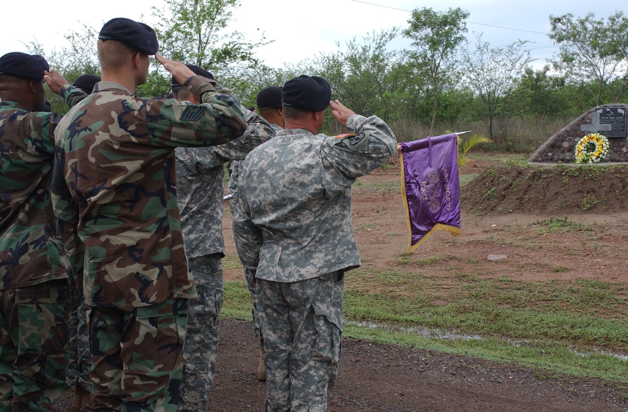 SOTO CANO AIR BASE, Honduras – Soldiers and Airmen from the Joint Security Forces render a salute during the memorial service for Army Staff Sgt. Randall J. Harris, who died from wounds suffered in the line of duty here on June 13, 1987.  Each year, Joint Task Force-Bravo holds a memorial service in remembrance of Sergeant Harris.   (U.S. Air Force photo/Tech. Sgt. Sonny Cohrs)