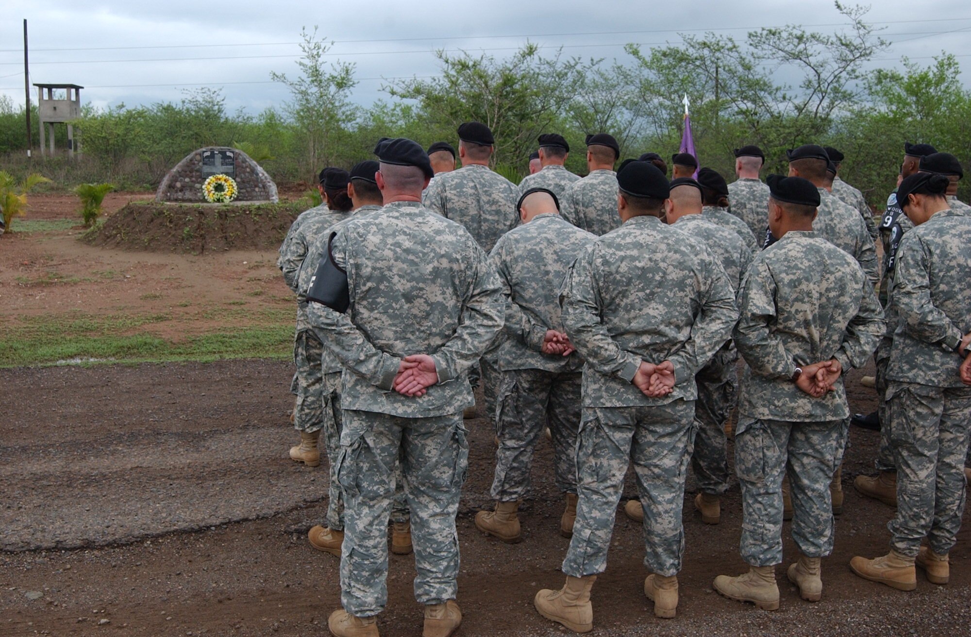 SOTO CANO AIR BASE, Honduras – Soldiers and Airmen from Joint Security Forces pause for a moment of silence during the memorial service for Army Staff Sgt. Randall J. Harris, who died from wounds suffered in the line of duty here on June 13, 1987.  Each year, Joint Task Force-Bravo holds a memorial service in remembrance of Sergeant Harris.   (U.S. Air Force photo/Tech. Sgt. Sonny Cohrs)