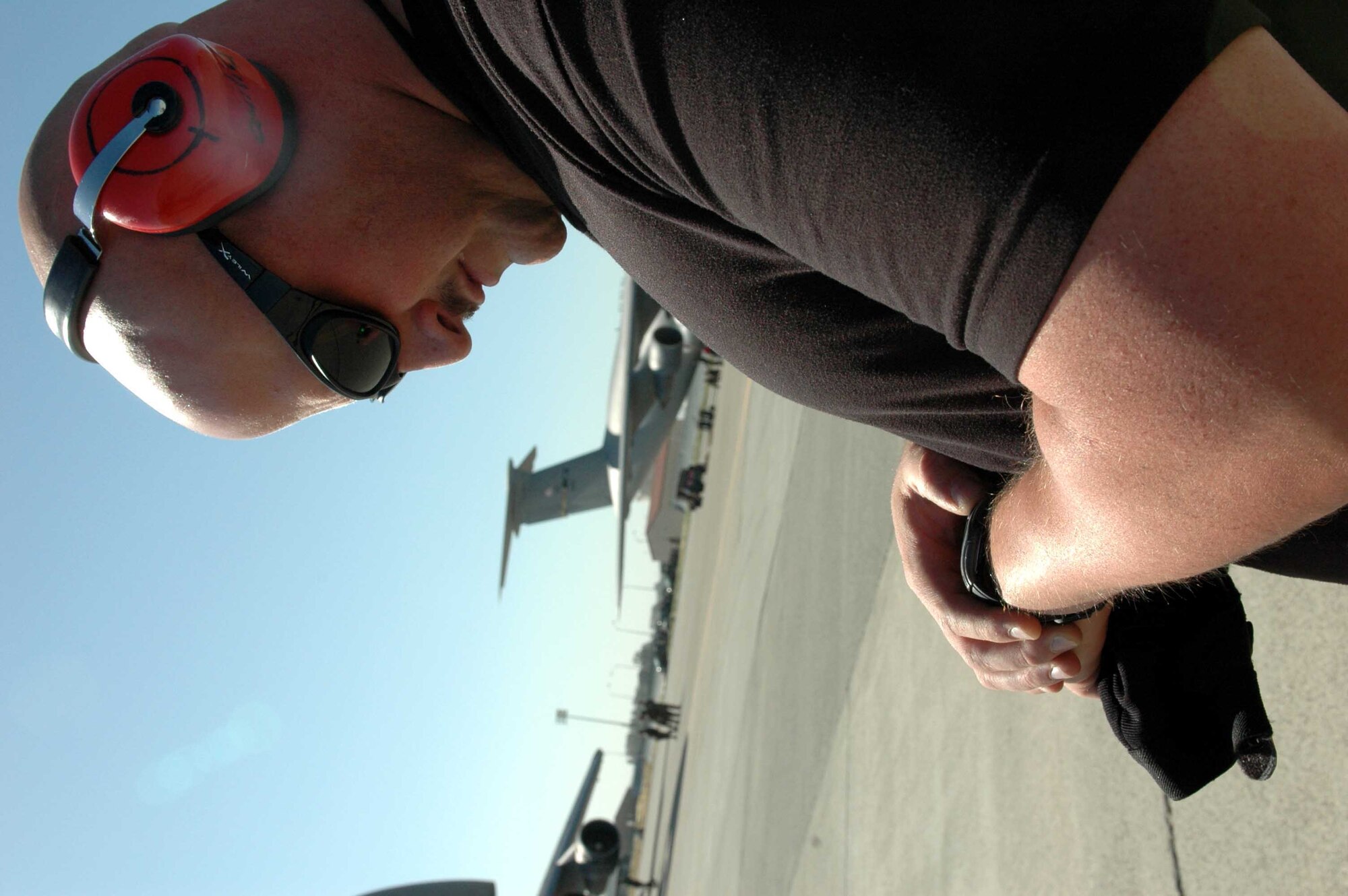 Tech. Sgt. Ken Quilici, 60th Aerial Port Squadron Rodeo Team leader, monitors the time during a 60th APS Rodeo Team C-5 engine running on/offload team practice June 11. The team must load and unload a C-5 and a C-17 in the fastest time possible with no safety violations. (U.S. Air Force photo by Staff Sgt. Candy Knight)
