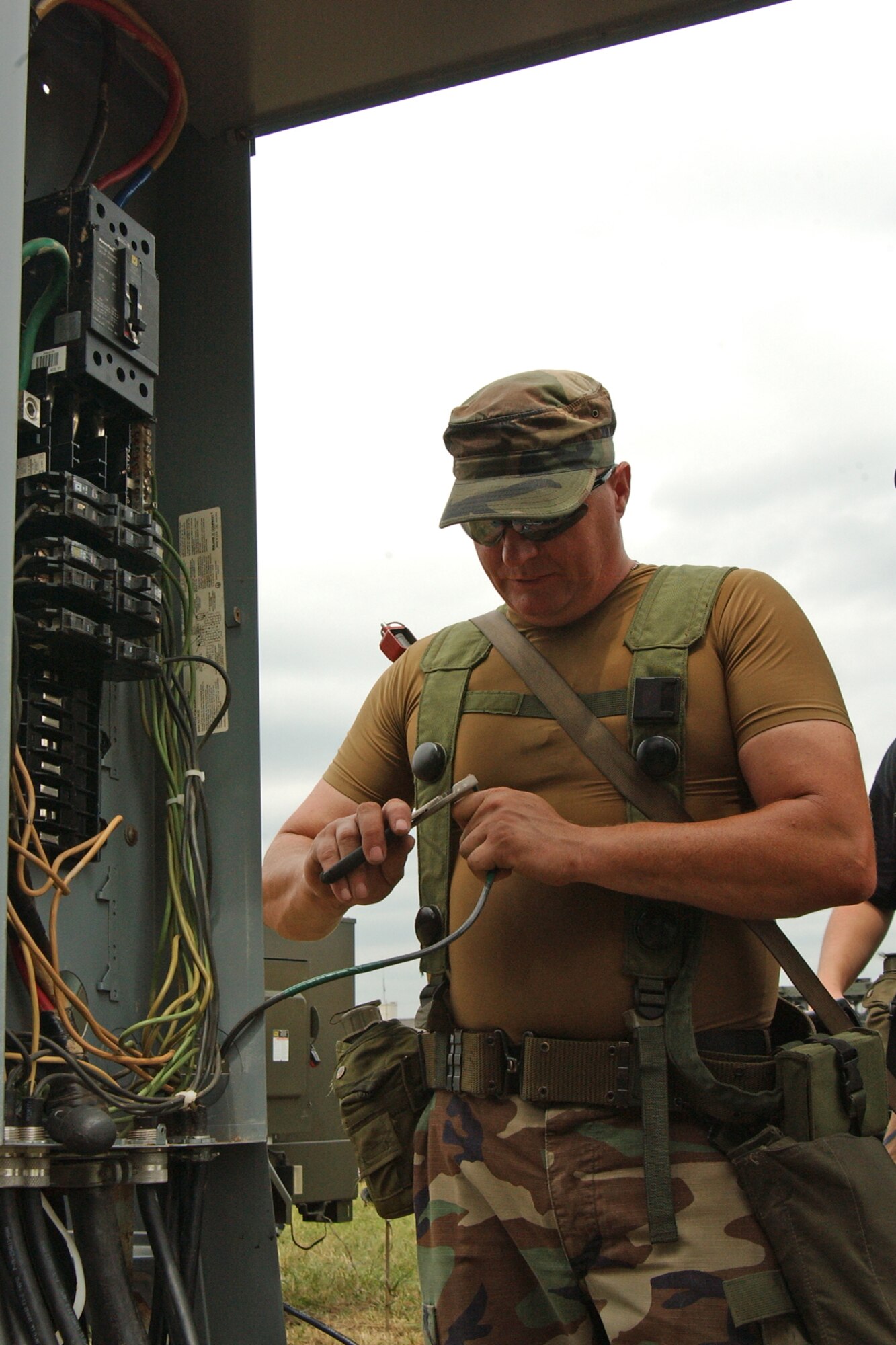 Senior Airman Kevin McDoniel, a 189th Civil Engineering Squadron electrician, works wiring for the Guard’s weekend exercise called Hog Heaven. (Photo by Master Sgt. Dianna Seerey)