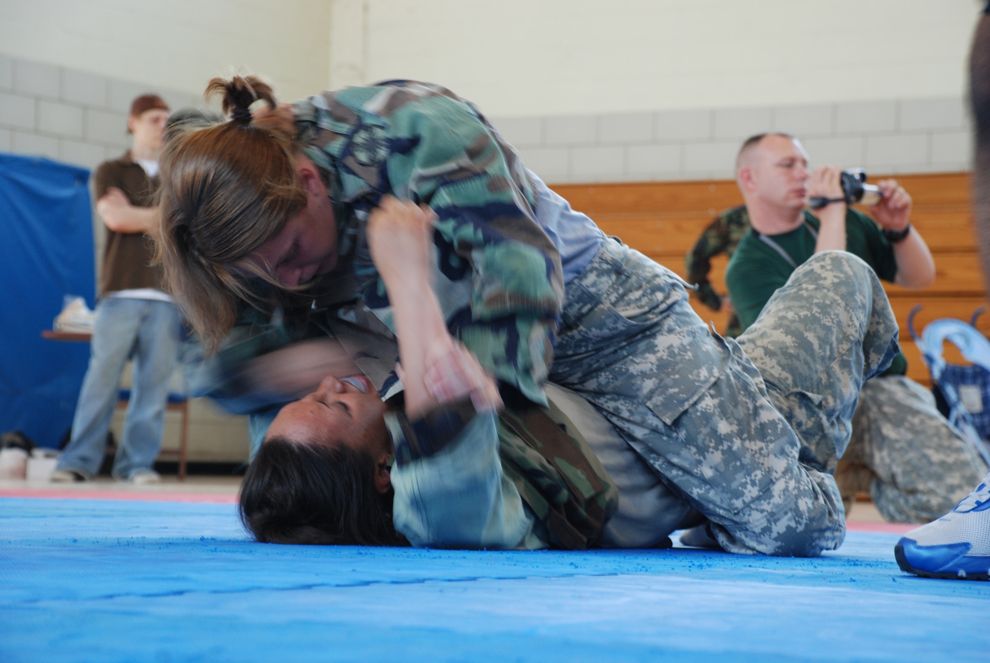 Private First Class Michele Thomas, Delta Company 264th Medical Battalion, and Private First Class Angel Steward, 264th Medical Battalion, compete against each other during the Modern Army Combatives Tournament at the Hackney Fitness Center June 9. (U.S. Air Force photo/Airman 1st Class Jacob Corbin)