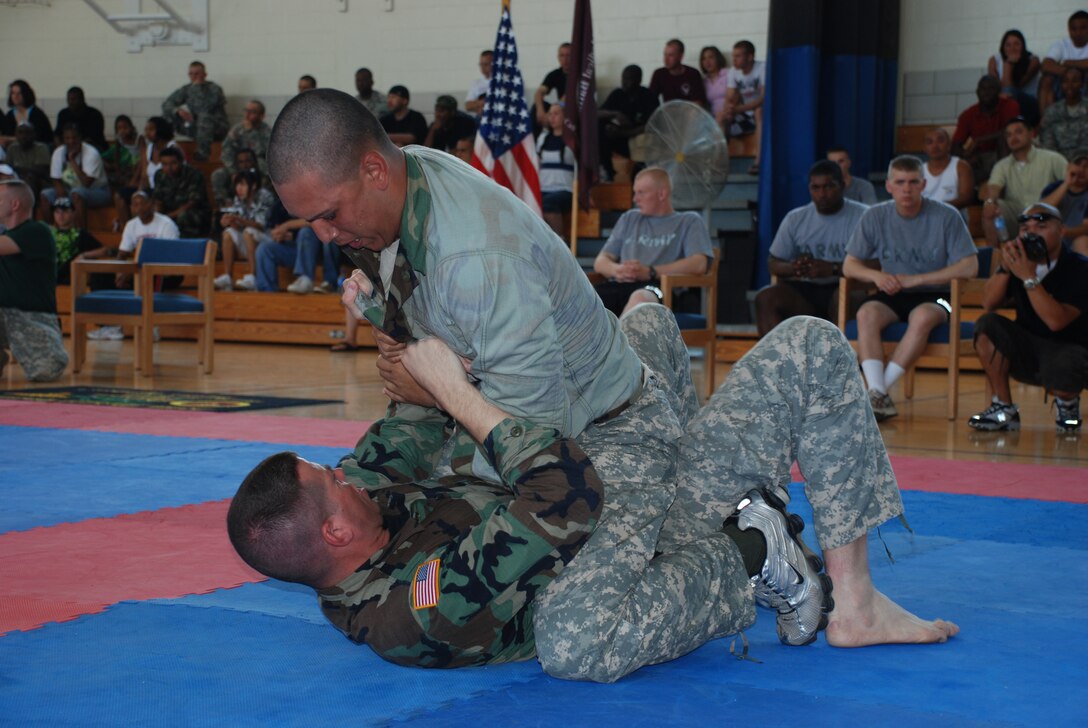 Private First Class John Barnes and Private Jazmani Medina, both from the 264th Medical Battalion, battle against each other during the Modern Army Combatives Tournament at the Hackney Fitness Center June 9. (U.S. Air Force photo/Airman 1st Class Jacob Corbin)