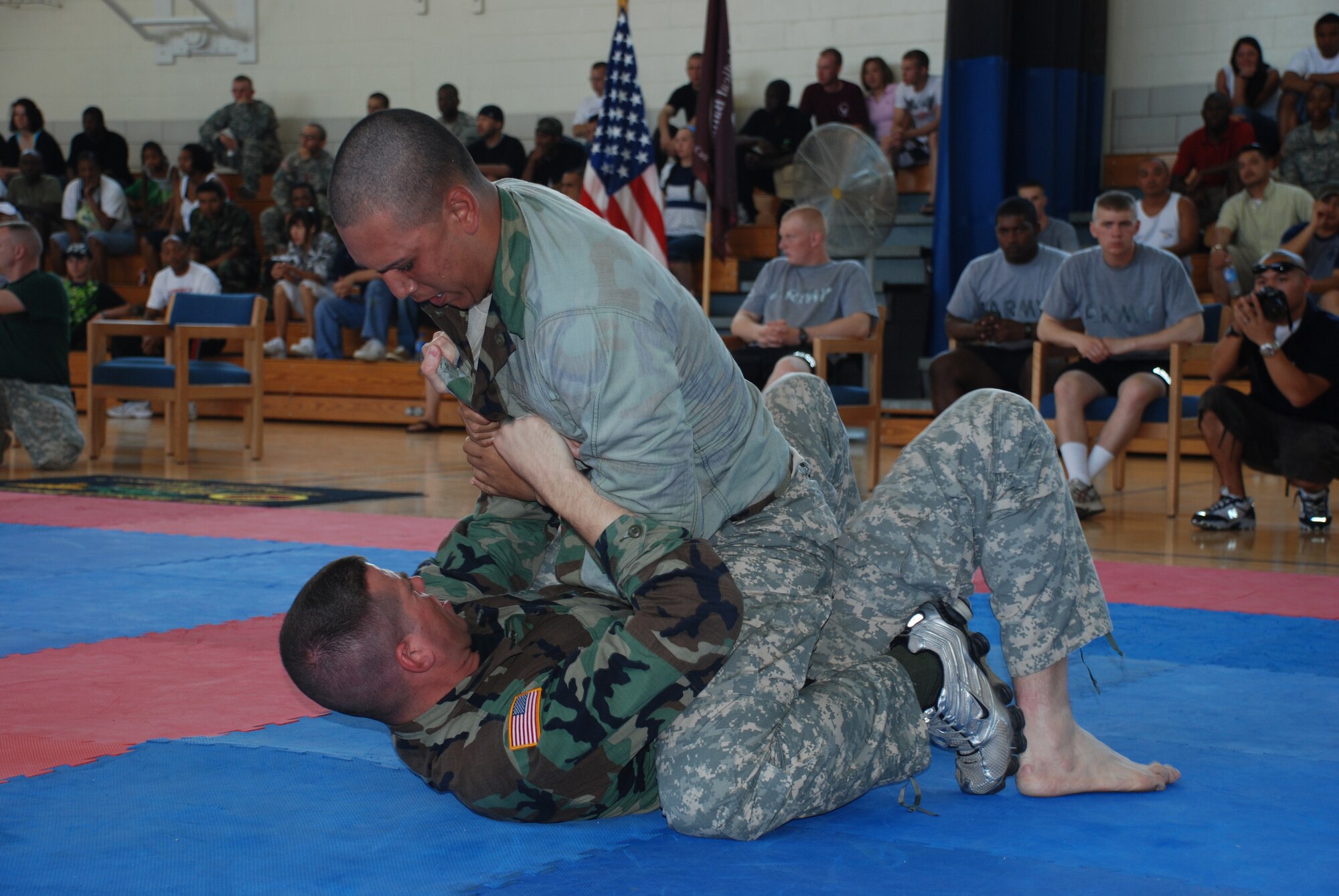 Private First Class John Barnes and Private Jazmani Medina, both from the 264th Medical Battalion, battle against each other during the Modern Army Combatives Tournament at the Hackney Fitness Center June 9. (U.S. Air Force photo/Airman 1st Class Jacob Corbin)