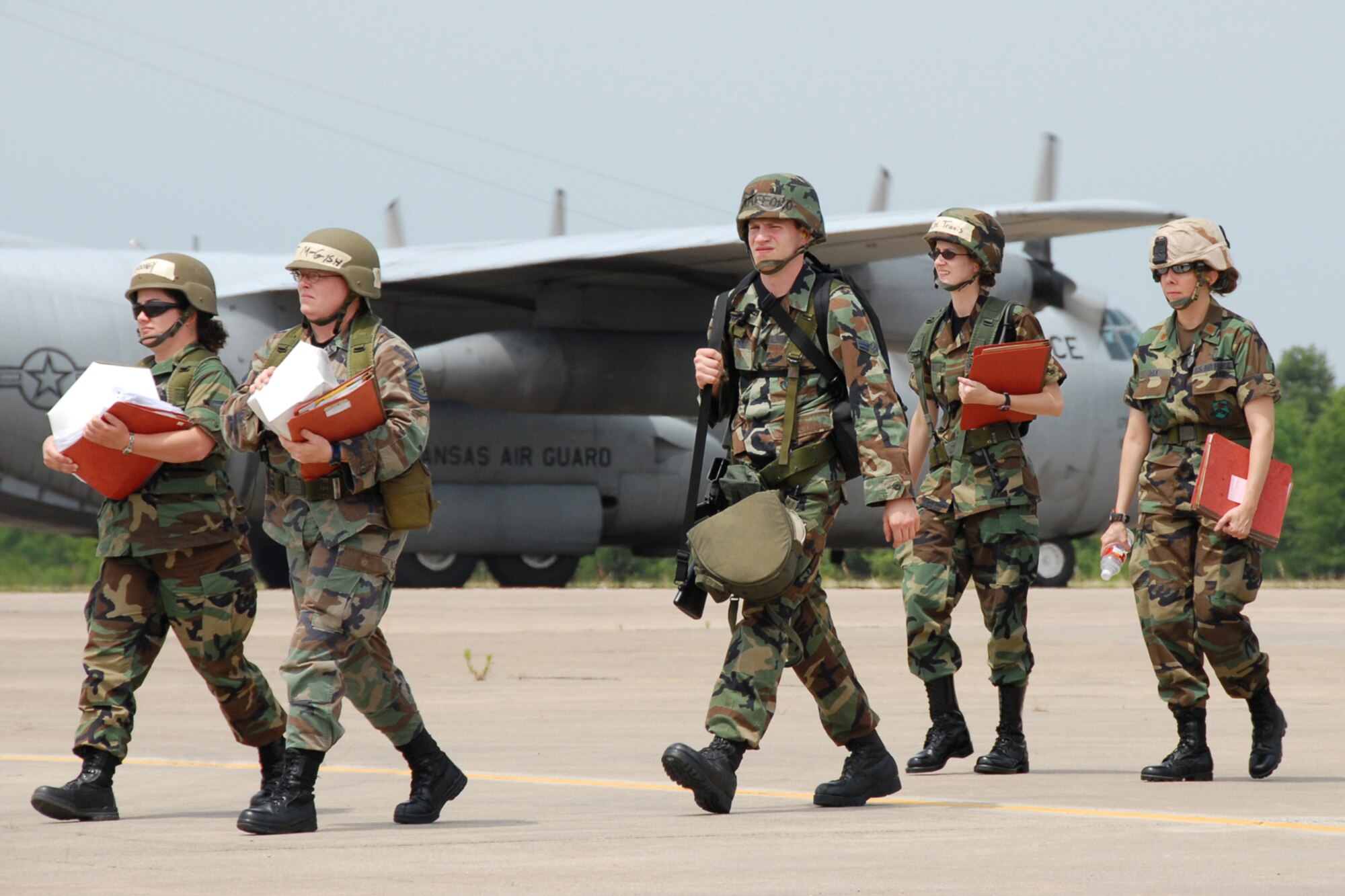 189th Airlift Wing Airmen walk across the tarmac after landing at their deployed location at the Christmas tree area of the base. (Photo by Tech. Sgt. Albert Petrie)