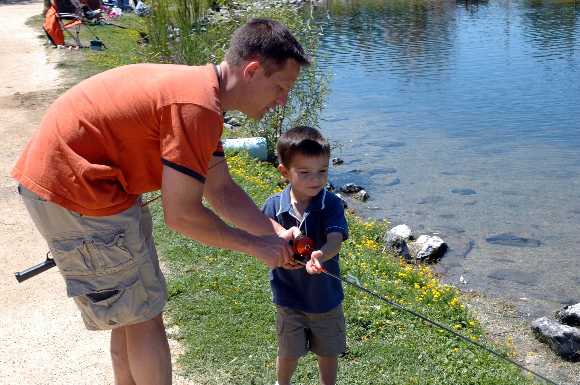 Maj. Greg Green, 60th Air Mobility Wing executive officer, helps his son David, age 3, get ready to cast his fishing pole during the Fishing Derby at the Duck Pond June 9. In 1966, former President Lyndon Johnson signed a presidential proclamation declaring the third Sunday of June as Father's Day. Former President Richard Nixon signed a law in 1972, making the holiday permanent.  (U.S. Air Force photo by Tech. Sgt. Donald Osborn)