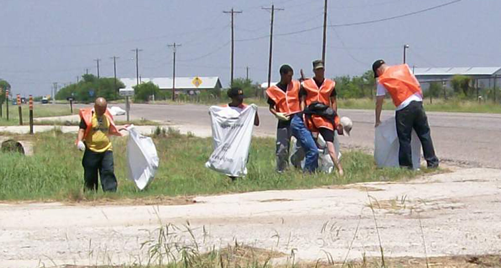 Members of the 7th Comptroller Squadron pick up trash along a two-mile section of Highway 277 June 7 as part of the adopt-a-highway program. Some base units have adopted parts of Abilene's roadways in an effort to keep the city beautiful and further enhance the Dyess-Abilene relationship. (Photo provided by Senior Master Sgt. Michael Guyer)