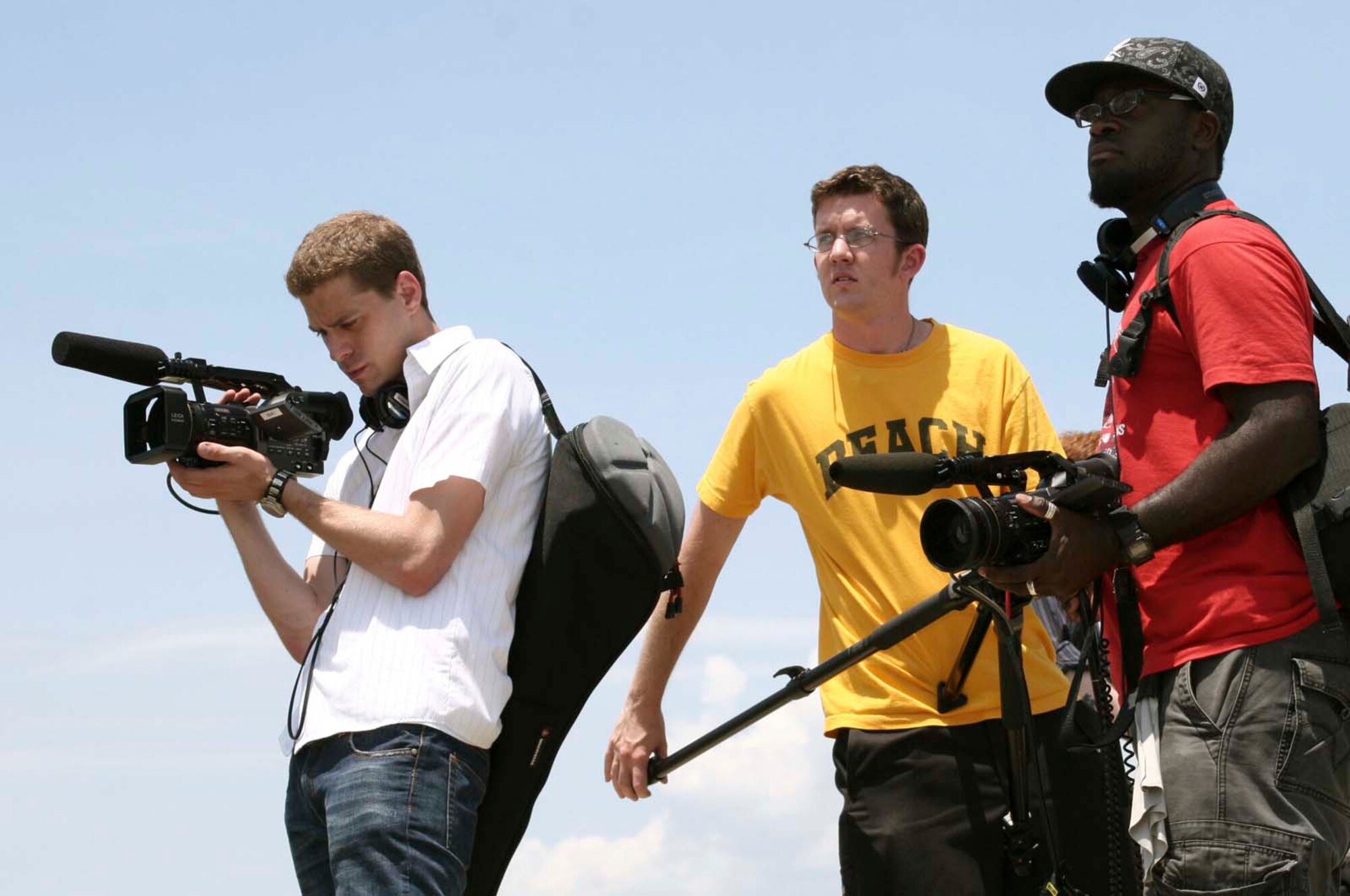 SHAW AIR FORCE BASE, S.C. -- Music Television crew members, (from left) Justin Zimmerman, Ki Whelan and Jerry Henry setup their camera equipment for an unexploded ordnance disposal drill at Poinsett Range June 8. The MTV crew is shooting footage of Senior Airman Kiel Anderson, 20th Civil Engineer Squadron explosive ordnance disposal technician, for the upcoming season of ''Engaged and Underage," a show that documents young people and life changing experiences. (U.S. Air Force photo/Airman Michael Cowley)