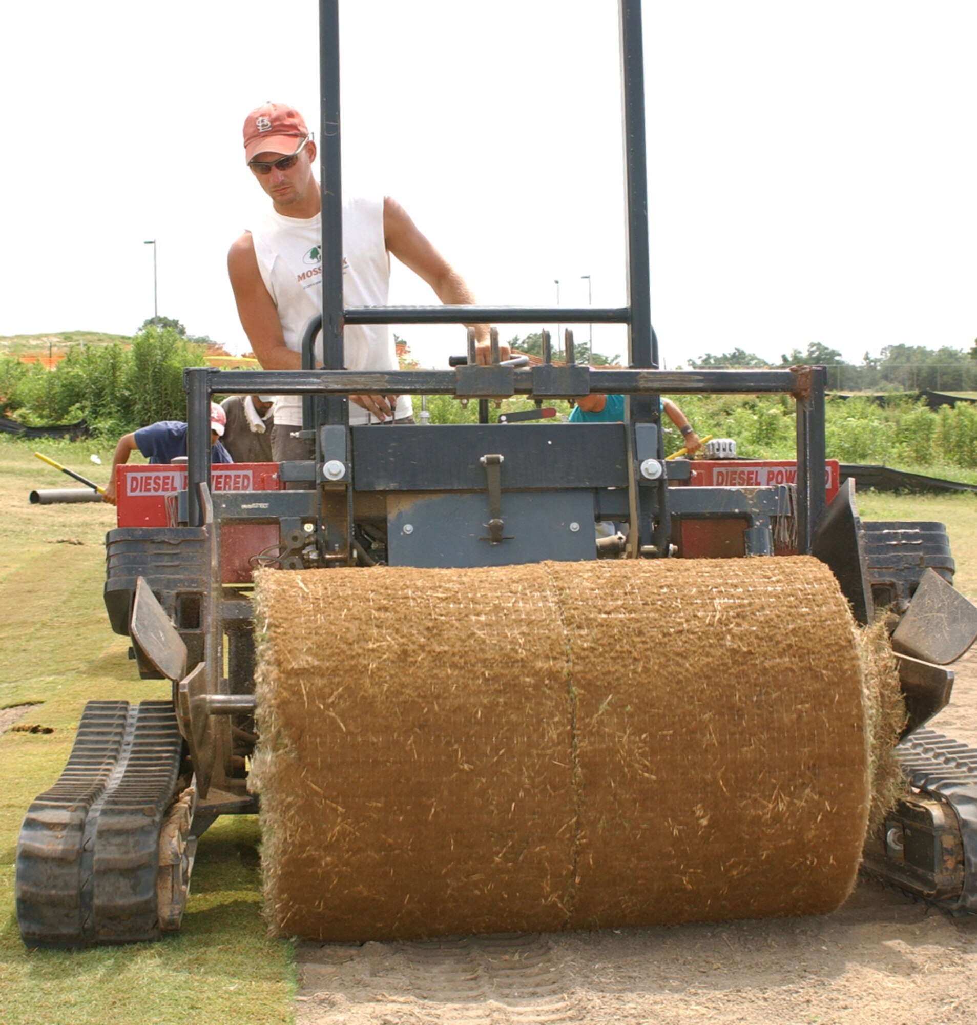 Equipment operator Brad Andrews from Southern Grass, West Point, rolls out sod on Hole 12 of Bay Breeze Golf Course June 6.  It’s part of a $4.5 million project that’s repairing damage from Hurricane Katrina and bringing the course up to U.S. Golf Association standards.  Bay Breeze is expected to reopen early this fall.  (U. S. Air Force photo by Kemberly Groue)
