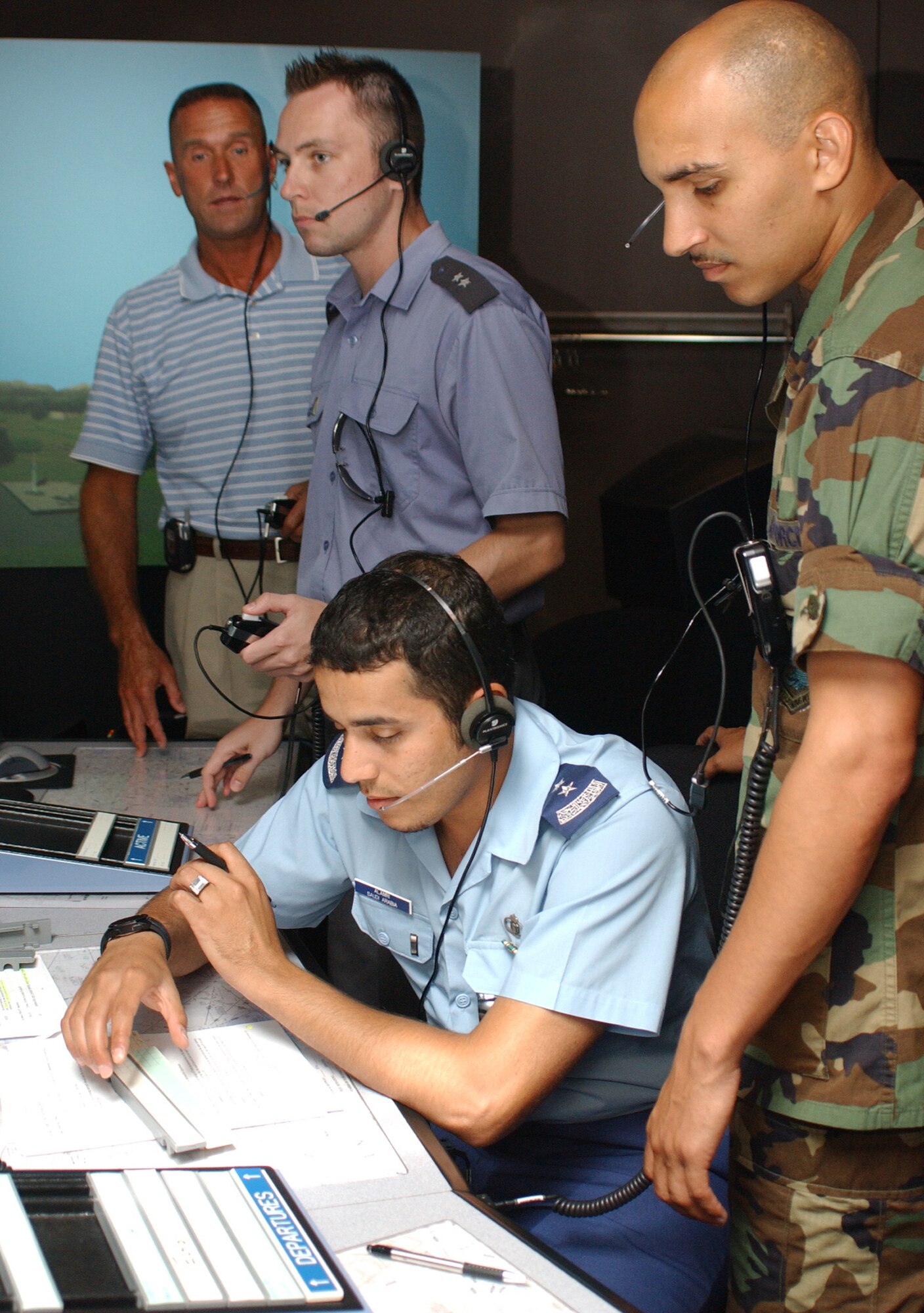 From top left, instructor Steve Harberson, Lieutenants Wadowski and Alamri and Capt. Jason Newcomer, another instructor, train inside the air traffic control tower simulator in Cody Hall.  (U. S. Air Force photo by Kemberly Groue)