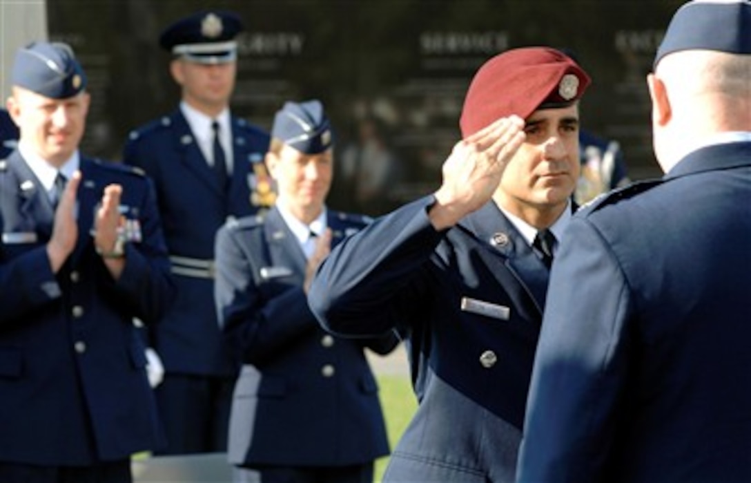Senior Master Sgt. Ramon Colon-Lopez salutes Air Force Chief of Staff Gen. T. Michael Moseley after being presented the Air Force Combat Action Medal. The medal was presented to six airmen in a ceremony at the Air Force Memorial in Arlington, Va., June 12. 