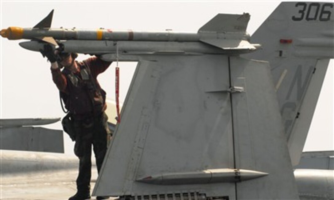 U.S. Navy Petty Officer 2nd Class Daniel Porter checks an AIM-9 Sidewinder missile for proper mounting on an F/A-18C Hornet aircraft, prior to flight operations aboard the aircraft carrier USS John C. Stennis (CVN 74) on May 28, 2007.  The John C. Stennis Carrier Strike Group is conducting operations in the Persian Gulf.  