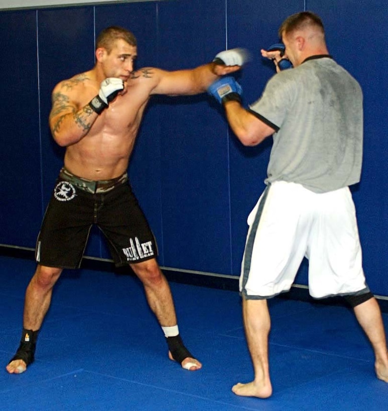 Cpl George Lockhart (left), a cryptological analyst with 2nd Radio Battalion spar with First Lt. Gary Hess as part of his daily training routine at Wright's Gym June 13 in preparation for up coming fight in Louisville Ky. Official Marine Corps photo by Cpl. Michael Knight.