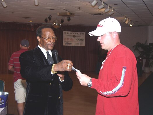 ANDERSEN AIR FORCE BASE, Guam - James Jackson rewards a customer during an event at the Top of the Rock.  Mr. Jackson passed away while performing his duties as assistant manager of the Top of the Rock, Andersen's club, May 24. (Photo by Ralph Ridgeway/36th Services Squadron)