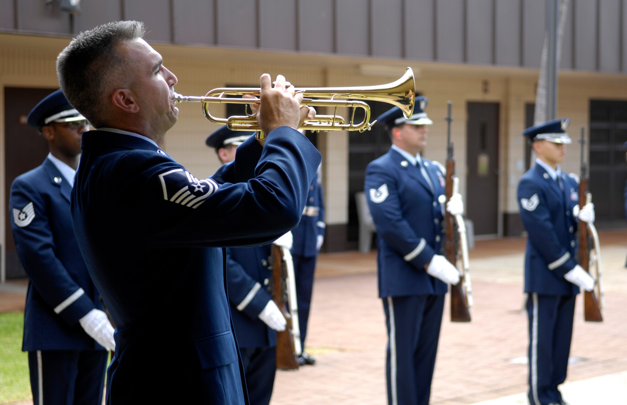 A bugler plays “Taps” during a memorial service honoring Senior Airman William Newman at the base chapel at Hickam Air Force Base, Hawaii June 13, 2007. Airman Newman, an explosive ordnance disposal technician assigned to the 15th Civil Engineer Squadron, was killed June 7 by an improvised explosive device, which detonated while he was supporting Army and Iraqi security forces near the village of Mishna, Iraq. (U.S. Air Force photo by Tech. Sgt. Shane A. Cuomo)