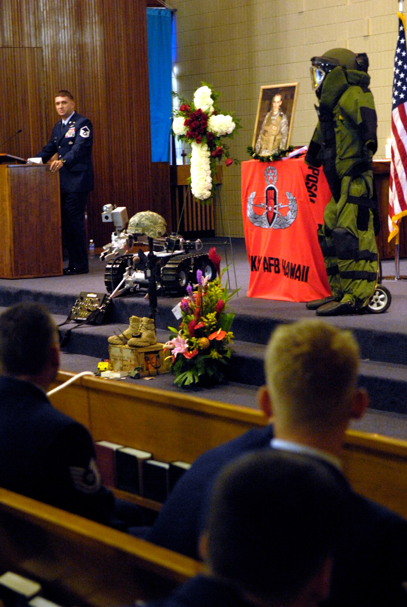 A member of the explosive ordnance disposal flight gives a eulogy during a memorial service honoring Senior Airman William Newman at the base chapel at Hickam Air Force Base, Hawaii June 13, 2007. Airman Newman, an explosive ordnance disposal technician assigned to the 15th Civil Engineer Squadron, was killed June 7 by an improvised explosive device, which detonated while he was supporting Army and Iraqi security forces near the village of Mishna, Iraq. (U.S. Air Force photo by Tech. Sgt. Shane A. Cuomo)