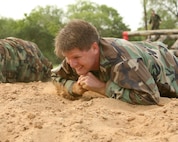 Col. Eric Wilbur, 37th Training Wing vice commander at Lackland Air Force Base, Texas, digs in during the low crawl June 11, 2007. Brig. Gen. Darrell Jones, a former 37th TRW commander, and Colonel Wilbur ran the basic military training obstacle course with the basic trainees on its reopening day. (USAF photo by Robbin Cresswell)