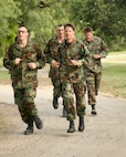 Brig. Gen. Darrell Jones, a former 37th Training Wing commander at Lackland Air Force Base, Texas, runs the basic military training obstacle course with basic trainees June 11, 2007. (USAF photo by  Robbin Cresswell)